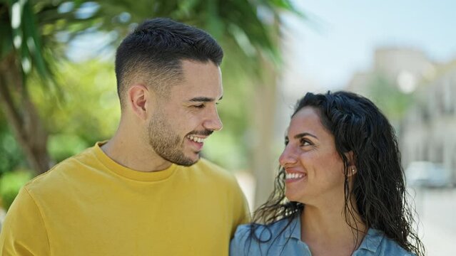 Man and woman couple smiling confident looking each other at park