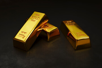 Stacks of pure gold bar on dark background. Represent business and finance concept idea.