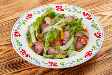 salad with ham on the wooden background