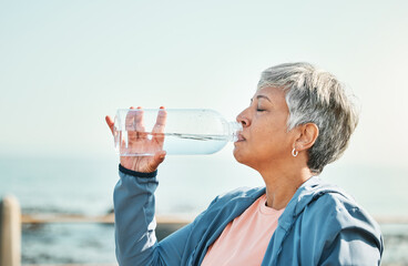Senior woman, drinking water and health with fitness, hydration and break during workout outdoor....