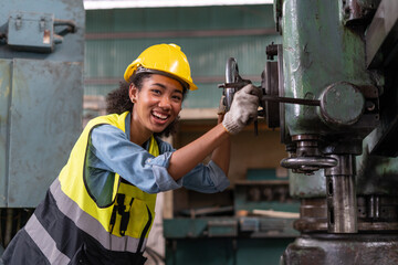 happy african american engineer worker woman smiling and working with machine in factory . cheerful...