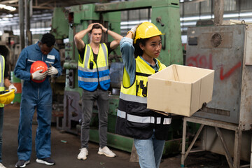 African American engineer worker woman fired from job carrying cardboard boxes with worry coworker...