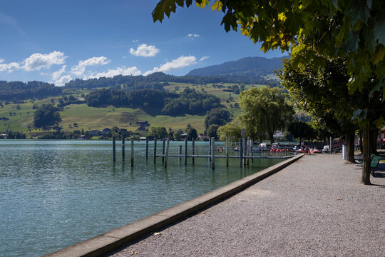 View of Sarnersee lake and the picturesque lakeside walkway at Sarnen in the canton of Lucerne in Switzerland. Scenic Swiss summer landscape with copy space below.