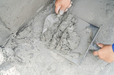 Hand plasterer keep wet gray cement mix on floor, Hand worker job on site construction  