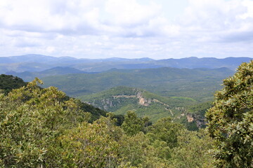 Fototapeta premium Overview of the National Park of Barbagia with limestone rocks and green forest hill, mountain. Central Sardinia, Italy, summer day