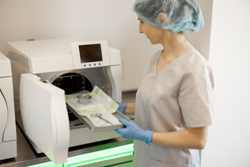 Medical worker sterilizes instruments after a surgical operation