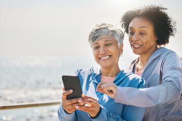 Senior woman, daughter and reading phone at the beach or social media, blog or post about workout or walk on promenade. Elderly mother, girl and profile picture with water or together on screen