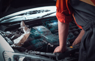 Automotive repair shop in the background of a futuristic virtual graphic touch user interface for the EV electric car technology industry concept.