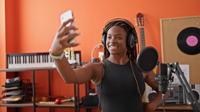 African american woman musician make selfie by smartphone smiling at music studio