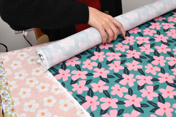 woman choosing between different printed fabrics