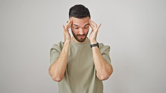 Young hispanic man suffering for headache over isolated white background