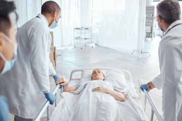 Obraz premium Doctors, theater and push woman in bed for emergency surgery for cancer treatment. Medical professional, team or surgeon rush patient to operation, er or hospital clinic to save a life for healthcare