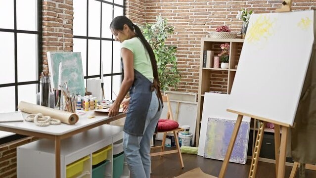 Young latin woman artist smiling confident drawing at art studio