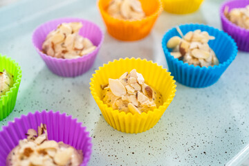 Lemon poppy seed muffins garnished with almond slivers