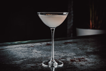 alcohol cocktail in a glass stands on a table in a bar or restaurant