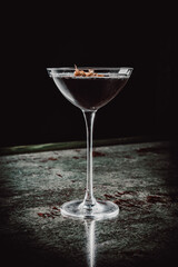 alcohol cocktail in a glass stands on a table in a bar or restaurant