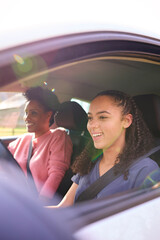 Teenage Girl In Car Having Driving Lesson From Female Instructor Or Parent