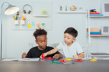 Two boys practicing their learning skills with science toys. With electronic electrical connection...