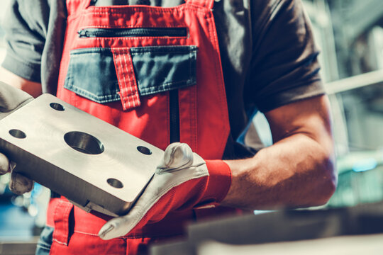 Metalworking Worker with Piece of Custom Made Metal Part