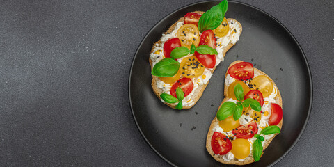 Fresh bread sandwiches with tomato cherry, cream cheese and basil leaves. Morning breakfast concept