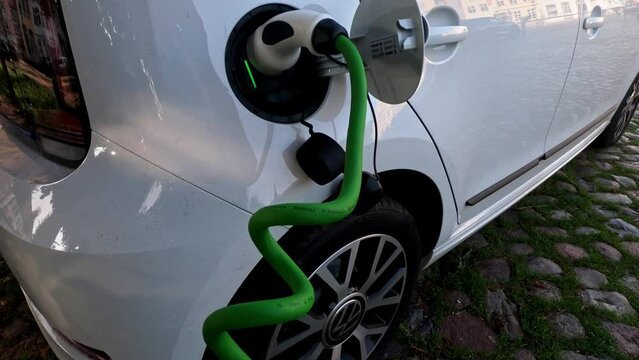 EV charging station for electric car in concept of green energy and eco power produced from sustainable source to supply to charger station in order to reduce CO2 emission .