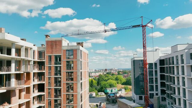 Construction Of A Multi-storey Building. Aerial Flying Over An Unfinished Red Brick House.