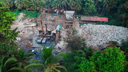 Aerial View of Tropical Waste Incineration Plant - Drone Footage. waste incinerator facility amidst lush tropics. Witness controlled disposal, minimizing landfill impact. drone shots over garbage dump