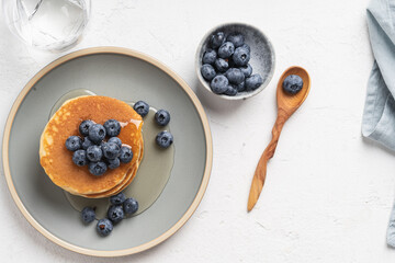 Pancakes with blueberries and honey top view
