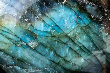 This is a colorful macro photo of a luminous and iridescent labradorite stone.  The patterns and...