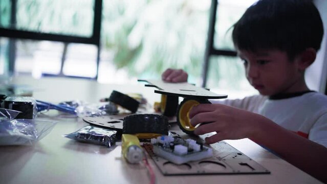 Young asia student learn online at home in coding robot arduino remotely, STEAM, mathematics engineering science technology