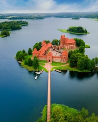 Aerial view of the Trakai castle surrounded by trees over the Galves Lake in Trakai, Lithuania