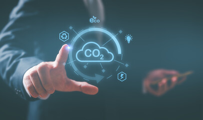 Hand touching CO2 reducing icon in concept of decrease carbon dioxide emission ,carbon footprint and carbon credit to limit global warming from climate change.net zero greenhouse gas emissions