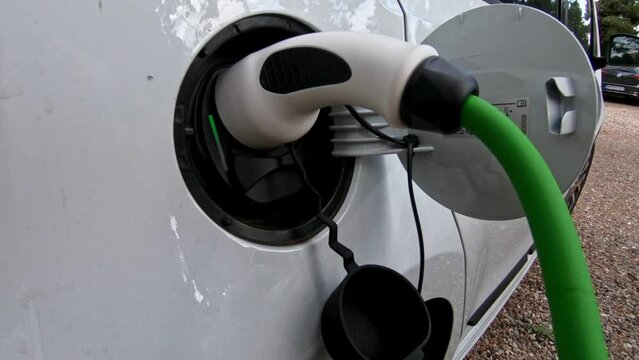 Close Up Of Power Cable Charging Environmentally Friendly Zero Emission Electric Car outdoors