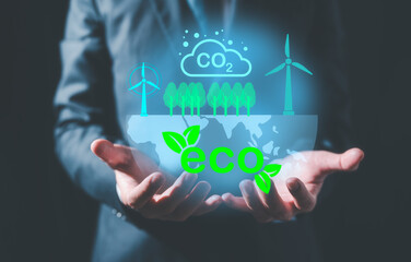 Hand holding virtual glob and sign CO2 reducing icon in concept of decrease carbon dioxide emission...