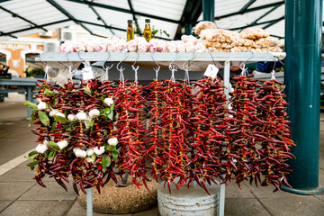 garlic and pepeprs with bottle of olive oil on the market for sale
