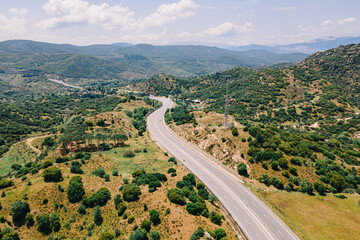Fototapeta na wymiar Aerial view of traffic highway through a green mountains
