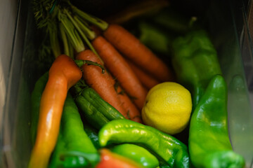 Group of vegetables with different colors, carrots, lemon and green pepper