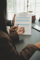 Judge gavel with Justice lawyers having team meeting at law firm background. Concepts of Law and Legal services.