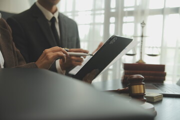 Judge gavel with Justice lawyers having team meeting at law firm background. Concepts of Law and...