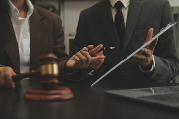 Judge gavel with Justice lawyers having team meeting at law firm background. Concepts of Law and...