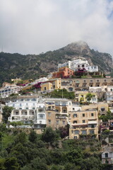 Naklejka premium Amalfi coast with beautifull houses and mountain in fog, Positano, Italy