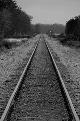 black and white photo of an empty railroad track, in the middle of nowhere