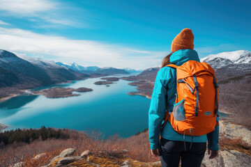 Naklejka premium Travel girl looking at the lake from the top of the mountain, autumn scene Generative AI