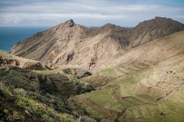 View of the mountains near to some water and grass on a mountain, La Gomera, Spain, Canary Islands