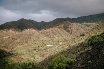 Fototapeta na wymiar Valley with some hills and mountains in the background, La Gomera, Spain,Canary Islands