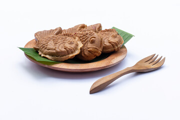 Fish-shaped taiyaki cake on white background