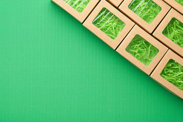 Green Friday backgrounds mock up. Sale Tag on green background. Paper shopping boxes and green tag. Environmentally friendly shopping idea, useful things on sale. Reducing excessive consumption.