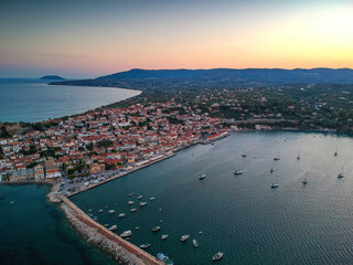 Fototapeta premium Aerial view over Koroni seaside city at sunset. Koroni, Messenia, Greece