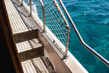 Boat deck with wooden floorings and sea