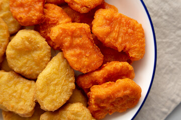 Homemade Spicy Chicken Nuggets Mix on a Plate, top view. Close-up.